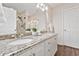 Bathroom with a double sink vanity, granite countertop, and a large mirror with vanity lights at 109 Rolling Oaks Ln, Benson, NC 27504