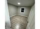 Comfortable bedroom with wood-look floors, fresh gray paint, and natural light at 1128 Horseshoe Rd, Durham, NC 27703