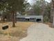 Inviting exterior view of a home with a well-manicured lawn, charming mailbox, and a cozy carport at 1128 Horseshoe Rd, Durham, NC 27703