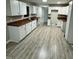 Open kitchen with sleek, white cabinets, modern fixtures, and stainless steel sink at 1128 Horseshoe Rd, Durham, NC 27703