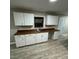 Well-lit kitchen with white cabinetry and wood countertops at 1128 Horseshoe Rd, Durham, NC 27703