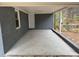 Covered porch with ample space for seating or storage, perfect for enjoying the outdoors in any weather at 1128 Horseshoe Rd, Durham, NC 27703