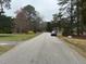 Residential street view, showcasing the neighborhood's charm with mature trees and a well-maintained road at 1128 Horseshoe Rd, Durham, NC 27703