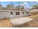 View of the backyard featuring a concrete patio and a freshly painted exterior at 1206 Dubose St, Garner, NC 27529