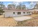 View of the backyard featuring a concrete patio and a freshly painted exterior at 1206 Dubose St, Garner, NC 27529