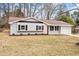View of home highlighting well maintained lawn, front yard landscaping and bright red door at 1206 Dubose St, Garner, NC 27529