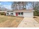 Charming home with gray siding, a red door, and an attached one-car garage at 1206 Dubose St, Garner, NC 27529