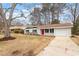 View of house showing the driveway, manicured lawn and a bright red front door at 1206 Dubose St, Garner, NC 27529