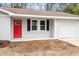 Charming exterior of home with bright red front door and attached single car garage at 1206 Dubose St, Garner, NC 27529