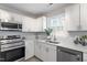 Modern kitchen showcasing stainless steel appliances, and bright white cabinets at 1206 Dubose St, Garner, NC 27529
