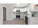 This modern kitchen features white cabinetry, a stainless steel stove, and plenty of counter space at 1206 Dubose St, Garner, NC 27529