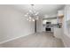 Open-concept living room and kitchen area with modern lighting at 1206 Dubose St, Garner, NC 27529