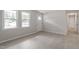 Living room features light floors, natural light, and a view to a hallway at 1206 Dubose St, Garner, NC 27529
