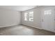 Living room features light wood floors and two windows offering natural light at 1206 Dubose St, Garner, NC 27529