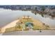 Overhead view of lakeside recreational area with mini golf, basketball court and green-roofed community building and parking at 121 Sacred Fire Rd, Louisburg, NC 27549