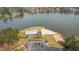 Aerial view showcases the lakefront community building, featuring a parking lot and private beach area for residents at 121 Sacred Fire Rd, Louisburg, NC 27549