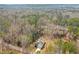 Aerial shot captures the home nestled in a wooded area, highlighting its secluded location and natural surroundings at 121 Sacred Fire Rd, Louisburg, NC 27549