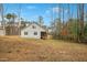 Expansive backyard featuring a screened porch and mature trees, perfect for outdoor entertaining and relaxation at 121 Sacred Fire Rd, Louisburg, NC 27549