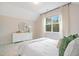 Bright bedroom with a dresser, mirror and large window with natural light at 121 Sacred Fire Rd, Louisburg, NC 27549