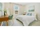 Bright bedroom featuring a cozy bed, modern desk, and a large window with natural light at 121 Sacred Fire Rd, Louisburg, NC 27549