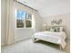 Bright bedroom with large window, light walls and carpet, and a bed with pillows and throw at 121 Sacred Fire Rd, Louisburg, NC 27549