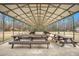 Covered picnic area with multiple tables, ideal for gatherings and outdoor dining, complemented by a nearby playground at 121 Sacred Fire Rd, Louisburg, NC 27549