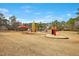 Community playground with various play structures, including slides, swings, and a climbing rocket, for enjoyment at 121 Sacred Fire Rd, Louisburg, NC 27549