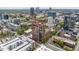 Aerial view of a cityscape featuring a modern high-rise building with surrounding greenery and urban infrastructure at 122 N Harrington St # 1105, Raleigh, NC 27603