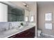 Dual sink bathroom featuring marble countertops, modern fixtures, and ample storage at 122 N Harrington St # 1105, Raleigh, NC 27603