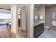 Elegant bathroom featuring marble floors, stylish fixtures, and a well-lit vanity area with a view into the bedroom at 122 N Harrington St # 1105, Raleigh, NC 27603