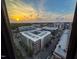 A stunning city view at sunset from a high-rise apartment window captures the vibrant cityscape below at 122 N Harrington St # 1105, Raleigh, NC 27603