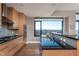 Modern kitchen features sleek appliances, stone countertops, and a large window showcasing city views at 122 N Harrington St # 1105, Raleigh, NC 27603