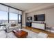 Stylish living room with comfortable seating, sleek entertainment center, and panoramic city views at 122 N Harrington St # 1105, Raleigh, NC 27603