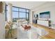 Spacious living room with hardwood flooring, large windows, and a stylish entertainment center at 122 N Harrington St # 1105, Raleigh, NC 27603