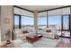 Bright and airy living room with floor-to-ceiling windows offering panoramic city views and comfortable seating at 122 N Harrington St # 1105, Raleigh, NC 27603