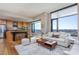 Bright open floorplan featuring a modern kitchen, large windows, hardwood floors, and comfortable seating at 122 N Harrington St # 1105, Raleigh, NC 27603