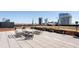 A roof deck featuring metal benches, planters, and stunning city views under a clear sky at 122 N Harrington St # 1105, Raleigh, NC 27603