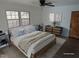 Serene bedroom featuring a large bed, decorative art, and ample natural light at 1269 Manns Chapel Rd, Pittsboro, NC 27312