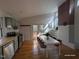 Bright dining area with modern table, brick accent wall, and access to outdoor deck at 1269 Manns Chapel Rd, Pittsboro, NC 27312