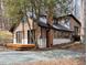 Exterior view of home with wood siding, brick chimney, and a large yard at 1269 Manns Chapel Rd, Pittsboro, NC 27312
