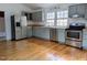 Bright kitchen with stainless appliances, wood countertops, painted cabinets, and hardwood floors at 1269 Manns Chapel Rd, Pittsboro, NC 27312