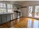 Kitchen with light-green cabinets, stainless steel appliances, wood counters, and an exterior exit to a deck at 1269 Manns Chapel Rd, Pittsboro, NC 27312