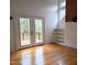 Bright living room with hardwood floors, built-in shelves, brick accent wall, and french doors to deck at 1269 Manns Chapel Rd, Pittsboro, NC 27312