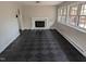 Bright living room with checkerboard floors, fireplace, and large windows allowing natural light at 1269 Manns Chapel Rd, Pittsboro, NC 27312