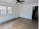 Room featuring hardwood floors, natural lighting from a pair of windows, and neutral wall color at 1269 Manns Chapel Rd, Pittsboro, NC 27312