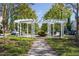 Community amenity featuring a white pergola surrounded by greenery and swings at 1319 Rodessa Run, Raleigh, NC 27607