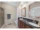 Bathroom featuring double vanity, tile flooring, and glass enclosed shower at 1319 Rodessa Run, Raleigh, NC 27607