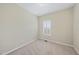 A bright, empty bedroom with carpet and a window with shuttered blinds at 1319 Rodessa Run, Raleigh, NC 27607