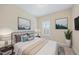 Nicely decorated bedroom featuring a queen-sized bed with blue accents and art at 1319 Rodessa Run, Raleigh, NC 27607