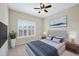 Bedroom with a ceiling fan, large window and a decorative painting hanging on the wall at 1319 Rodessa Run, Raleigh, NC 27607